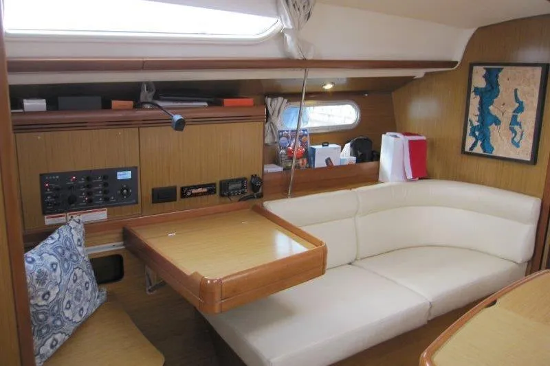 Angelucia Yacht Photos Pics Interior of 2008 Jeanneau Sun Odyssey 39i sailboat with cozy seating and navigation equipment.