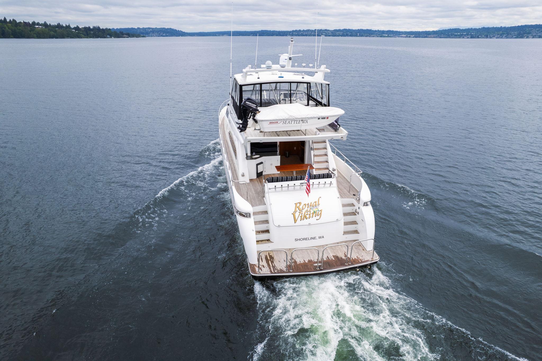 1999 Vitech 68' Pilothouse yacht cruising on open water, rear view.