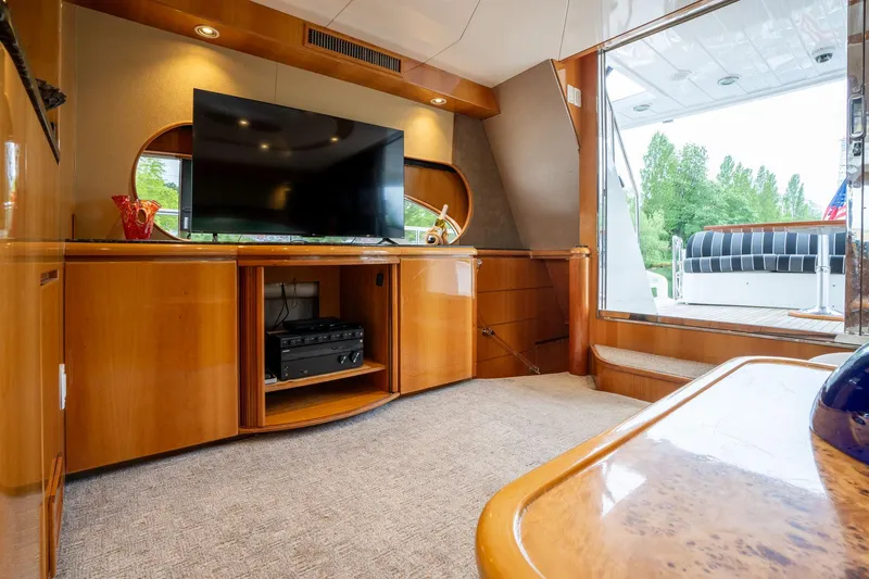 Royal Viking Yacht Photos Pics Luxurious interior of 1999 Vitech 68' Pilothouse yacht with TV and elegant wood finish.