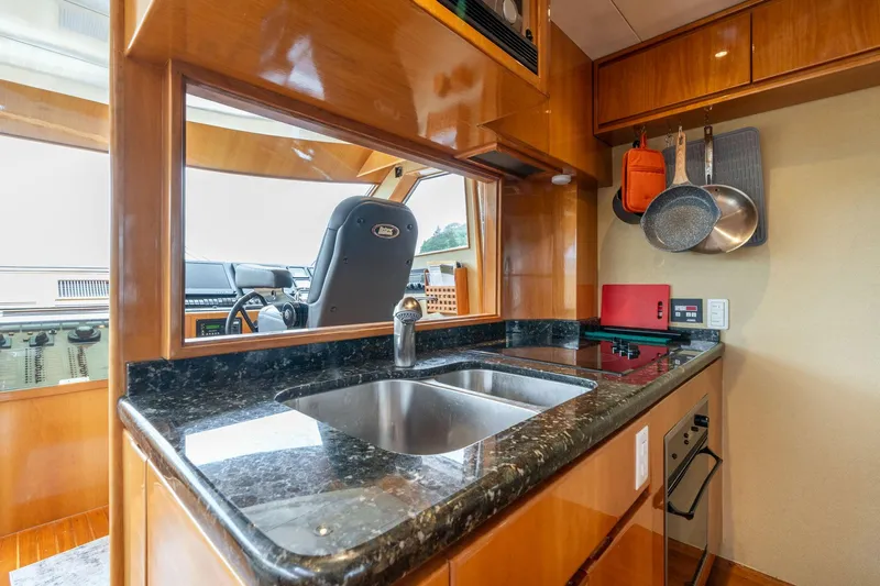 Royal Viking Yacht Photos Pics Luxurious kitchen in 1999 Vitech 68' Pilothouse yacht with granite countertops and modern appliances.