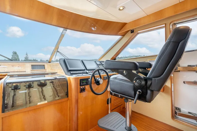 Royal Viking Yacht Photos Pics Pilothouse interior of 1999 Vitech 68' yacht, featuring modern controls and captain's chair.
