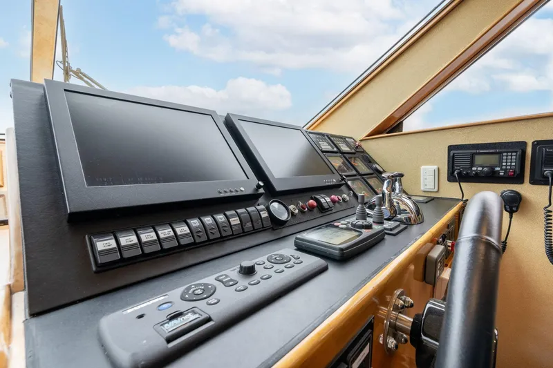 Royal Viking Yacht Photos Pics Pilothouse controls of 1999 Vitech 68' yacht with navigation screens and instruments.