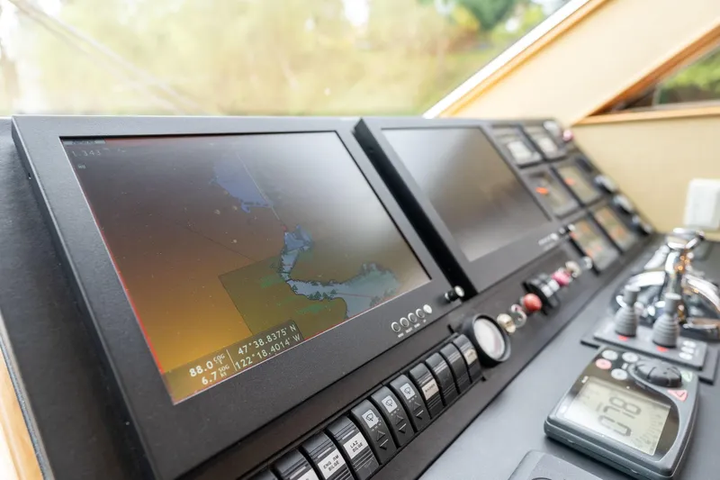 Royal Viking Yacht Photos Pics Control panel of 1999 Vitech 68' Pilothouse yacht with navigation screens and instruments.