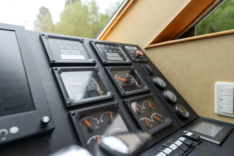Royal Viking Yacht Photos Pics Control panel of a 1999 Vitech 68' Pilothouse yacht, featuring gauges and switches.