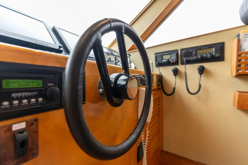 Royal Viking Yacht Photos Pics Pilothouse interior of 1999 Vitech 68' yacht, featuring steering wheel and navigation controls.