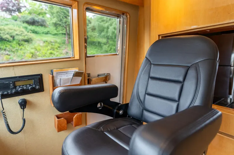 Royal Viking Yacht Photos Pics Luxurious pilothouse interior of 1999 Vitech 68' yacht with leather captain's chair.