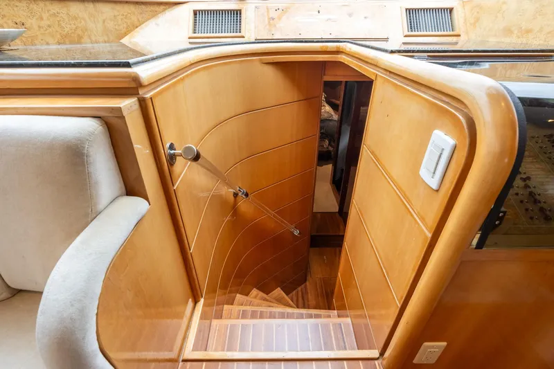 Royal Viking Yacht Photos Pics Interior staircase of 1999 Vitech 68' Pilothouse yacht with wooden finish.