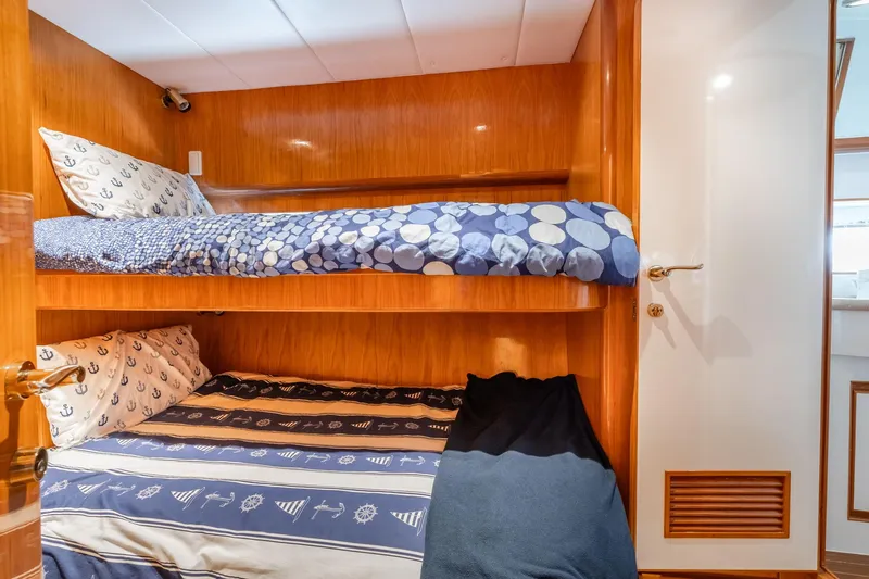 Royal Viking Yacht Photos Pics Bunk beds in 1999 Vitech 68' Pilothouse yacht cabin with nautical-themed bedding.