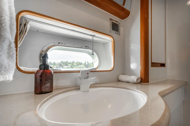 Royal Viking Yacht Photos Pics Luxurious bathroom interior of 1999 Vitech 68' Pilothouse yacht with sink and window view.