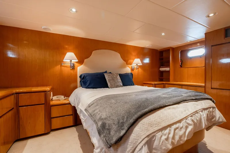Royal Viking Yacht Photos Pics Luxurious bedroom interior of 1999 Vitech 68' Pilothouse yacht with cozy lighting and elegant decor.