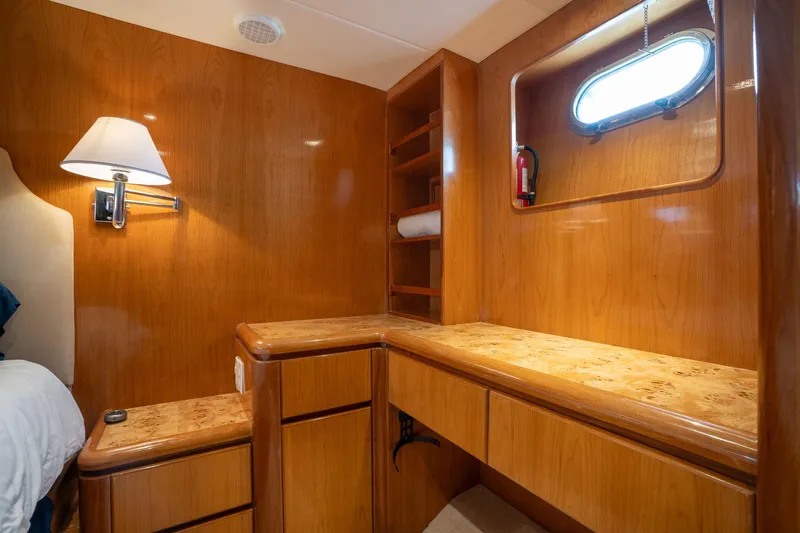 Royal Viking Yacht Photos Pics Luxurious wooden interior of 1999 Vitech 68' Pilothouse yacht cabin with desk and shelves.