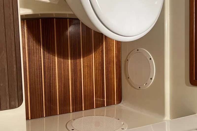 Wayfarer Yacht Photos Pics 2002 Hinckley Talaria 29C boat interior with wood paneling and white fixtures.