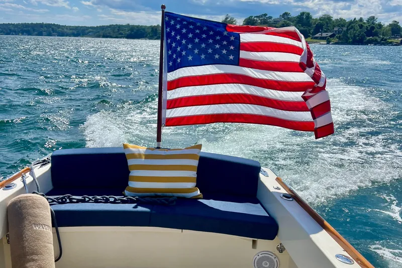 Wayfarer Yacht Photos Pics American flag on 2002 Hinckley Talaria 29C boat, cruising on a sunny day.