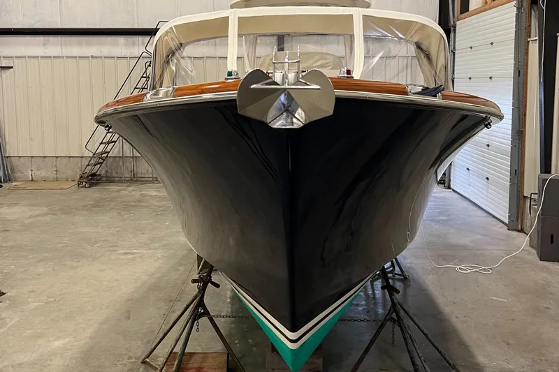 Wayfarer Yacht Photos Pics 2002 Hinckley Talaria 29C boat in storage, front view, black hull, indoor setting.