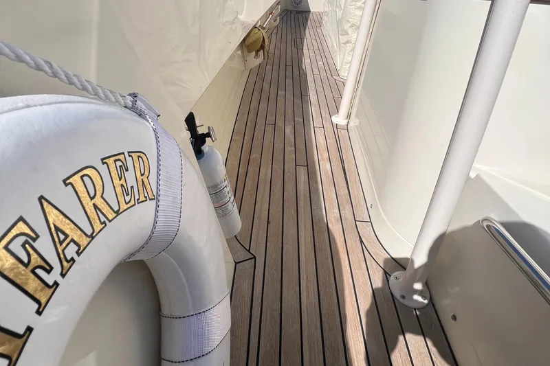 Wayfarer Yacht Photos Pics Hinckley Talaria 29C 2002 yacht deck with life preserver and wooden flooring.