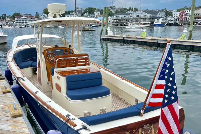 Wayfarer Yacht Photos Pics 2002 Hinckley Talaria 29C boat docked, featuring blue seating and an American flag.