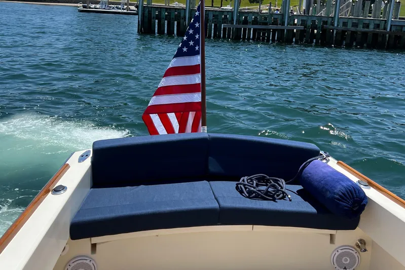 Wayfarer Yacht Photos Pics 2002 Hinckley Talaria 29C boat with American flag, blue seating, and waterfront view.