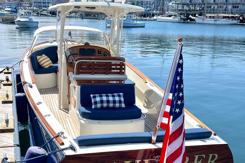 Wayfarer Yacht Photos Pics 2002 Hinckley Talaria 29C boat docked, featuring elegant seating and American flag.