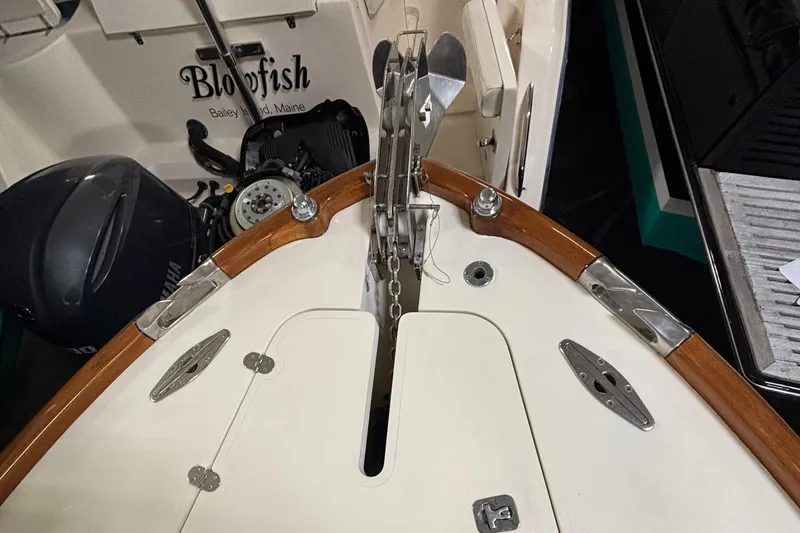 Wayfarer Yacht Photos Pics Hinckley Talaria 29C 2002 boat deck with anchor chain and motor, labeled "Blowfish."