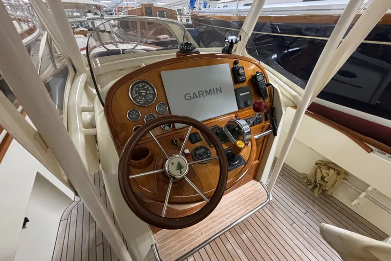 Wayfarer Yacht Photos Pics 2002 Hinckley Talaria 29C helm with Garmin navigation system and wooden steering wheel.