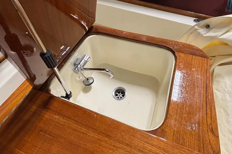 Wayfarer Yacht Photos Pics Hinckley Talaria 29C 2002 boat sink with wooden countertop and chrome faucet.
