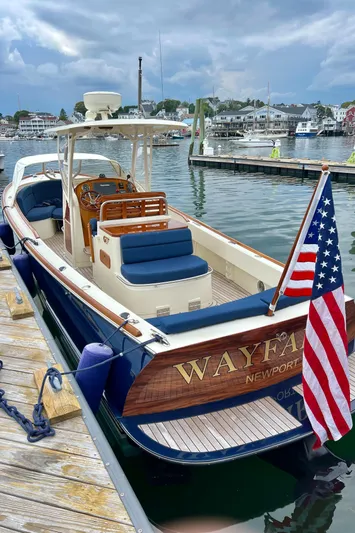 Wayfarer Yacht Photos Pics 2002 Hinckley Talaria 29C boat docked, displaying American flag, with scenic marina backdrop.