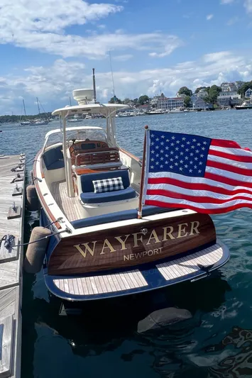 Wayfarer Yacht Photos Pics 2002 Hinckley Talaria 29C boat docked, displaying American flag, with "Wayfarer Newport" on stern.
