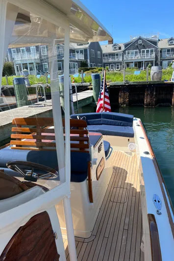 Wayfarer Yacht Photos Pics 2002 Hinckley Talaria 29C docked, featuring elegant wooden deck and American flag.