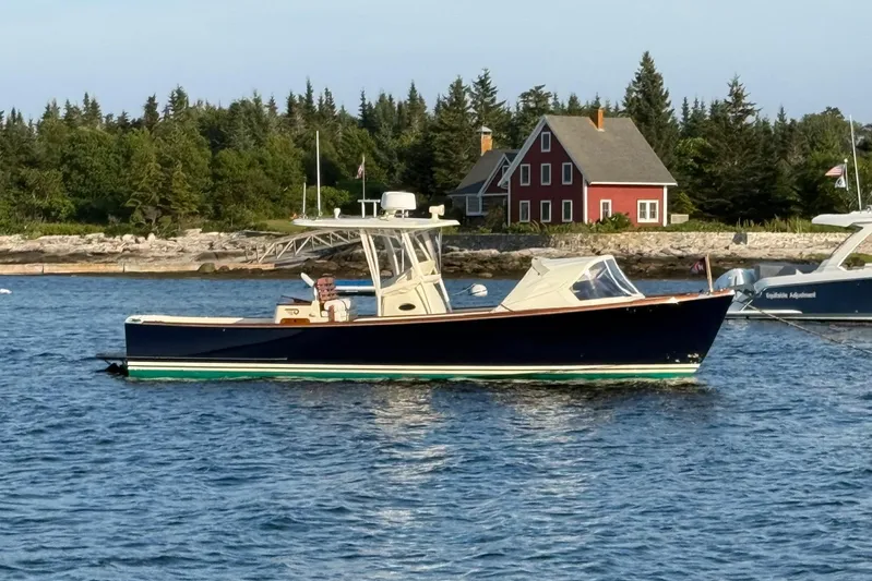 Wayfarer Yacht Photos Pics 2002 Hinckley Talaria 29C boat on water near a red house and trees.