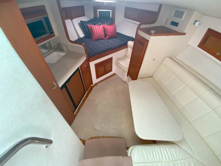 Arbutus Yacht Photos Pics Interior of 2006 Cabo 32 Express HT yacht with cozy seating and compact kitchen.
