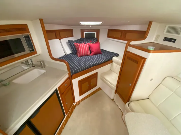 Arbutus Yacht Photos Pics Interior of 2006 Cabo 32 Express HT boat with cozy cabin and kitchenette.