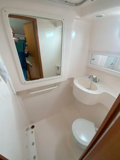 Arbutus Yacht Photos Pics Bathroom interior of 2006 Cabo 32 Express HT boat, featuring sink and toilet.