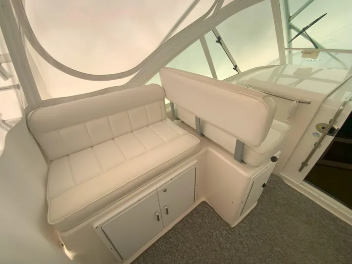 Arbutus Yacht Photos Pics 2006 Cabo 32 Express HT interior with white seating and storage cabinets.