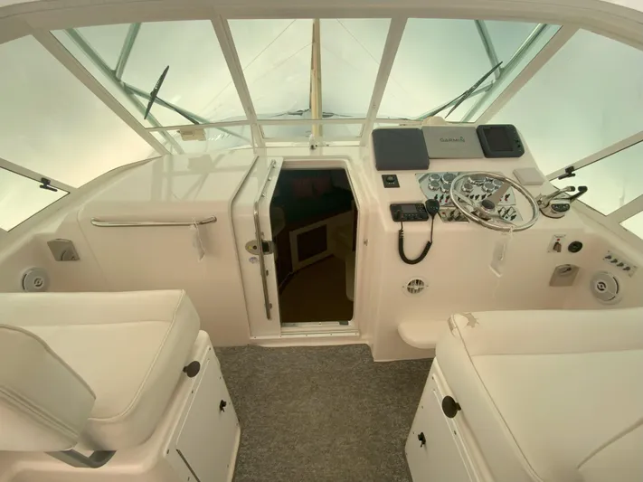 Arbutus Yacht Photos Pics Helm of 2006 Cabo 32 Express HT boat with steering wheel and navigation controls.