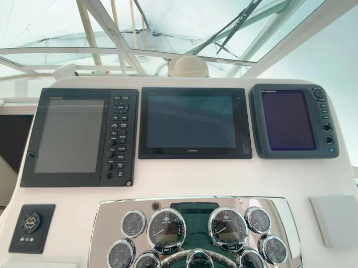 Arbutus Yacht Photos Pics Helm of 2006 Cabo 32 Express HT with navigation displays and gauges.