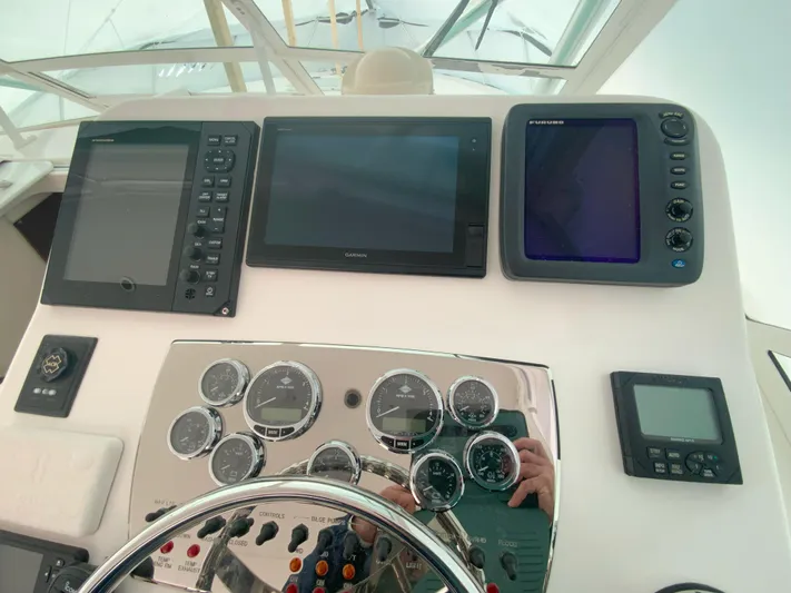 Arbutus Yacht Photos Pics Control panel of a 2006 Cabo 32 Express HT boat with navigation instruments.