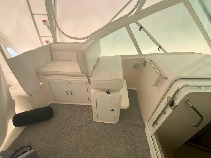 Arbutus Yacht Photos Pics 2006 Cabo 32 Express HT interior with cushioned seating and storage cabinets.