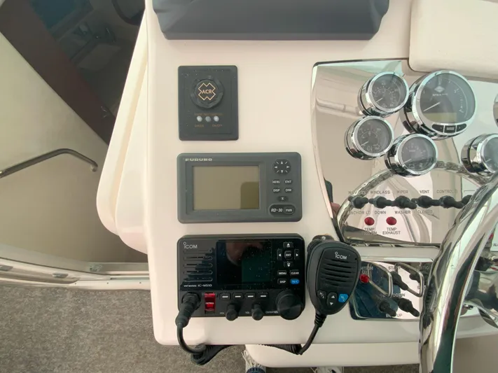 Arbutus Yacht Photos Pics Control panel of a 2006 Cabo 32 Express HT boat with navigation and communication equipment.