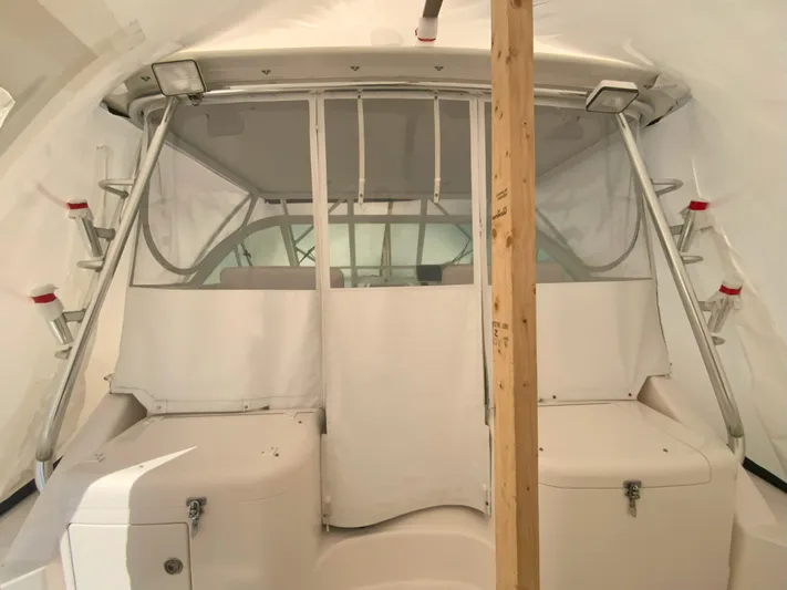 Arbutus Yacht Photos Pics 2006 Cabo 32 Express HT boat interior with white seating and protective cover.