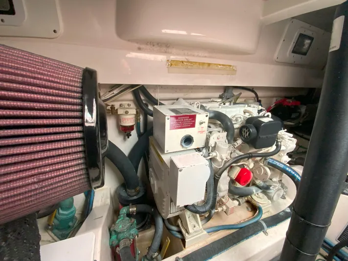 Arbutus Yacht Photos Pics Engine compartment of a 2006 Cabo 32 Express HT boat, showcasing mechanical components and wiring.