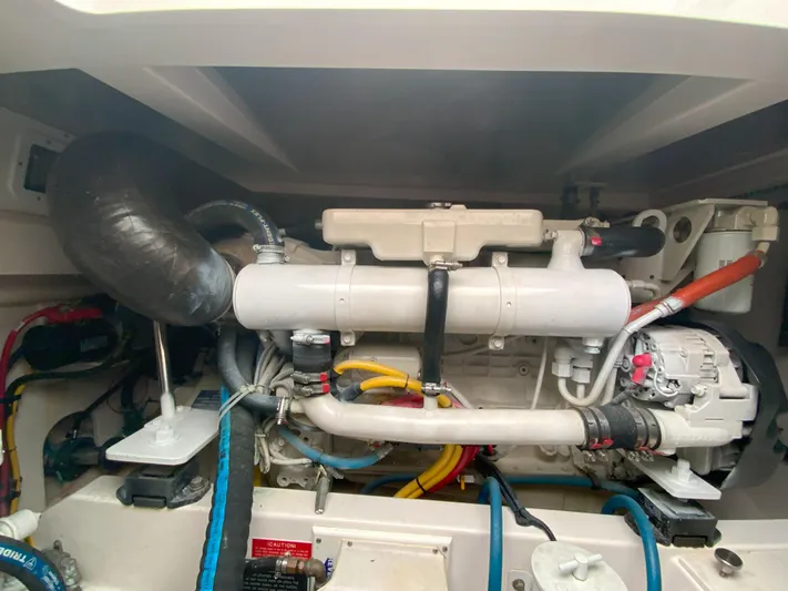 Arbutus Yacht Photos Pics Engine compartment of a 2006 Cabo 32 Express HT boat, showcasing mechanical components.