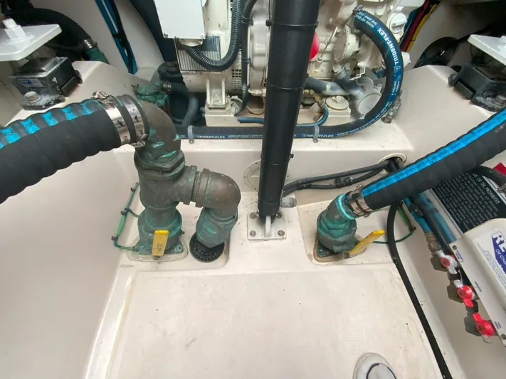 Arbutus Yacht Photos Pics Engine compartment of a 2006 Cabo 32 Express HT with visible hoses and fittings.