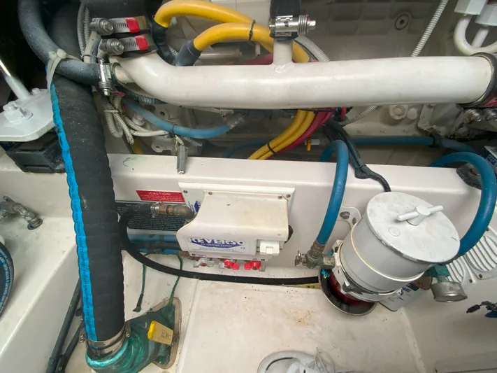 Arbutus Yacht Photos Pics Engine compartment of a 2006 Cabo 32 Express HT with various hoses and components.