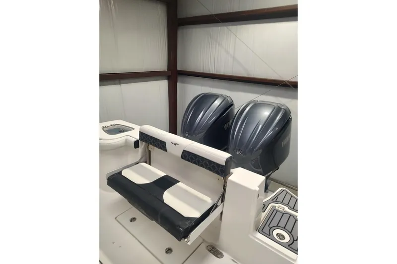  Yacht Photos Pics 2023 Tidewater 292 CC Adventure boat with dual outboard engines in storage.