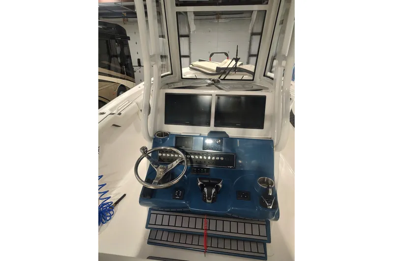 Yacht Photos Pics 2023 Tidewater 292 CC Adventure boat helm with dual screens and controls.