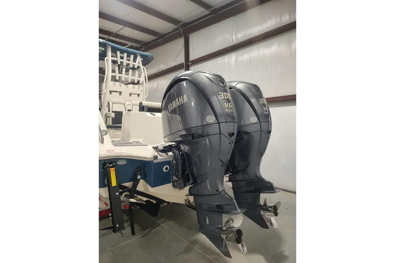  Yacht Photos Pics 2023 Tidewater 292 CC Adventure with dual Yamaha 300 V6 outboard engines in a warehouse.