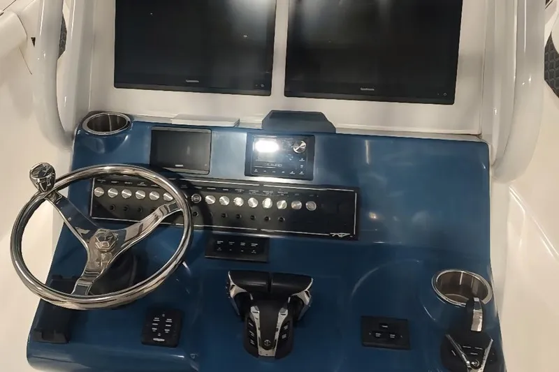  Yacht Photos Pics 2023 Tidewater 292 CC Adventure boat dashboard with dual screens and steering wheel.