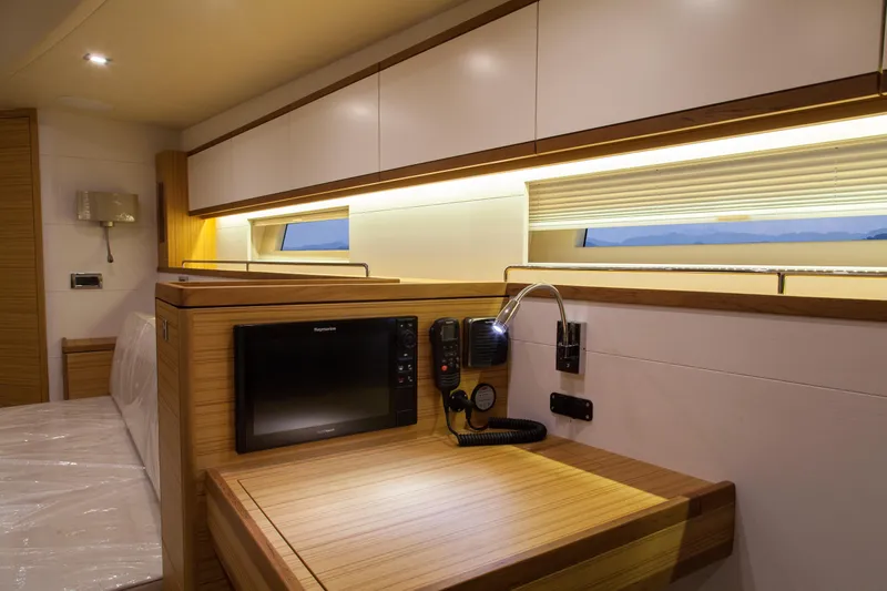  Yacht Photos Pics Luxurious interior of 2026 Mazarin 72 Cruiser/Racer with modern wood finish and built-in electronics.