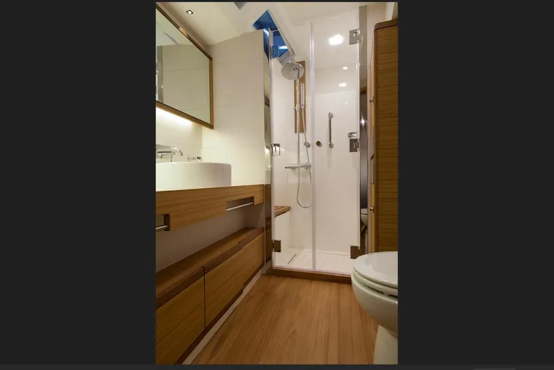  Yacht Photos Pics Luxurious bathroom in 2026 Mazarin 72 Cruiser/Racer yacht, featuring modern fixtures and wooden accents.