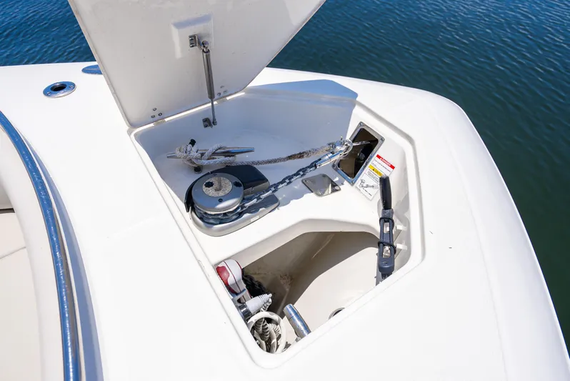  Yacht Photos Pics Boston Whaler 350 Realm 2021 anchor compartment with winch, open on calm water.